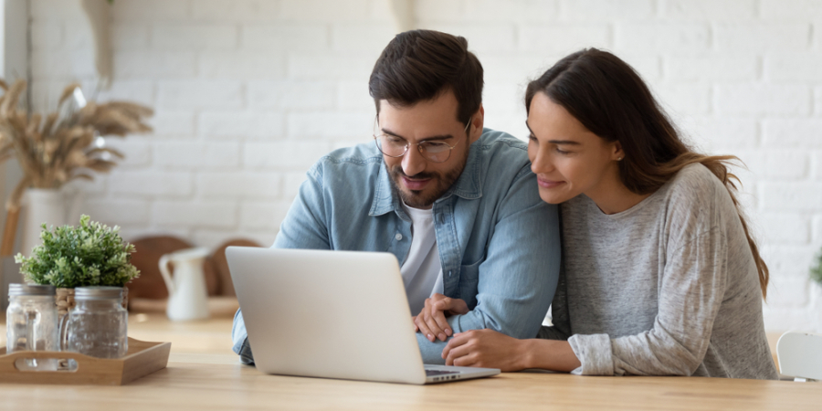 happy couple looking at computer